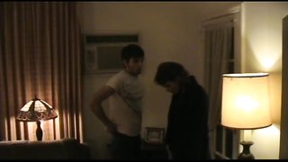 Babe in short black dress spanks submissive male on sofa