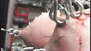 Extreme BDSM games in dungeon with metal chains and hooks