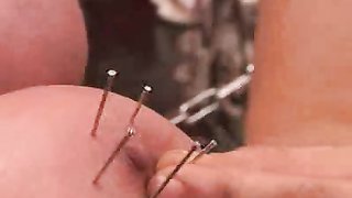 Master shoves sharp needles in her massive bonded boobs