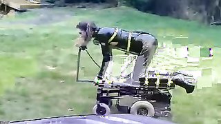 Sub chick in latex suit is sucking a dildo in doggy style pose