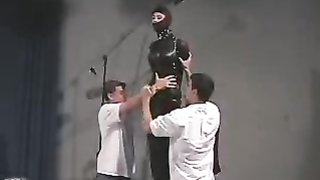 Bitch in latex suit gets prepared for a torture by two masters