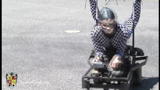 Stupid MILF slave in mask and suit bound to a moving cart