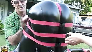 Tightly fastened slut in shiny latex has a spinning fun time face-down
