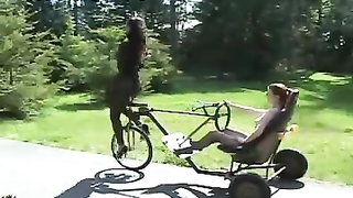Bound bitch in tight latex forced to drive a bicycle