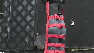 Female wearing a latex suit gets hanged and claustrophobically bound