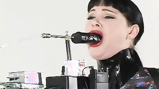 Let's a bound brunette's mouth with a machine dildo