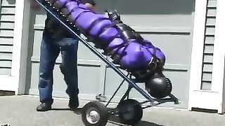 Slave in a purple bodysuit gets ready for a ride of a lifetime