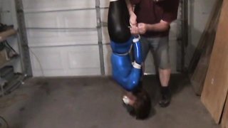 Beautiful brunette slave suspended from the ceiling