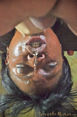 Suspended athletic ebony with a white dick in the mouth