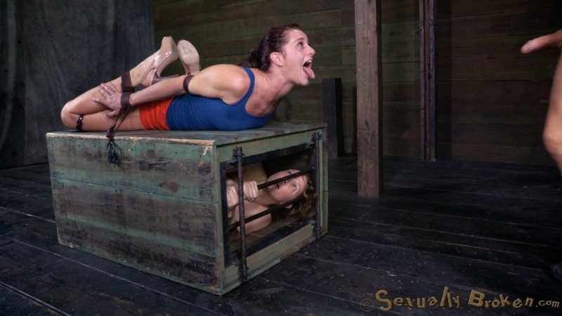 Belted white doll and a black snake in her mouth