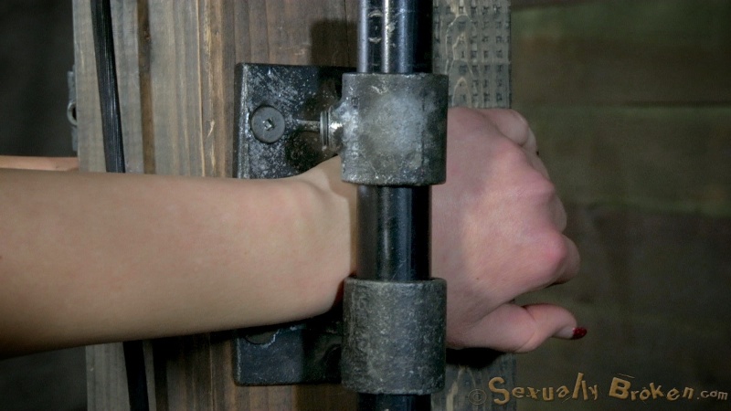 Restrained redhead sitting on a sybian and getting her throat fucked