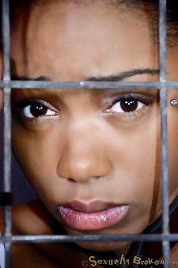 Caged ebony slave sucks a big black sausage