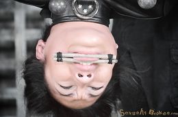 Asian slut in leather straitjacket forced to suck
