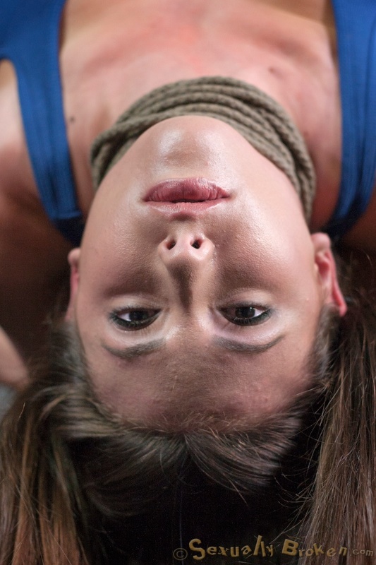 Lass hangs upside down and submissive sucks her master